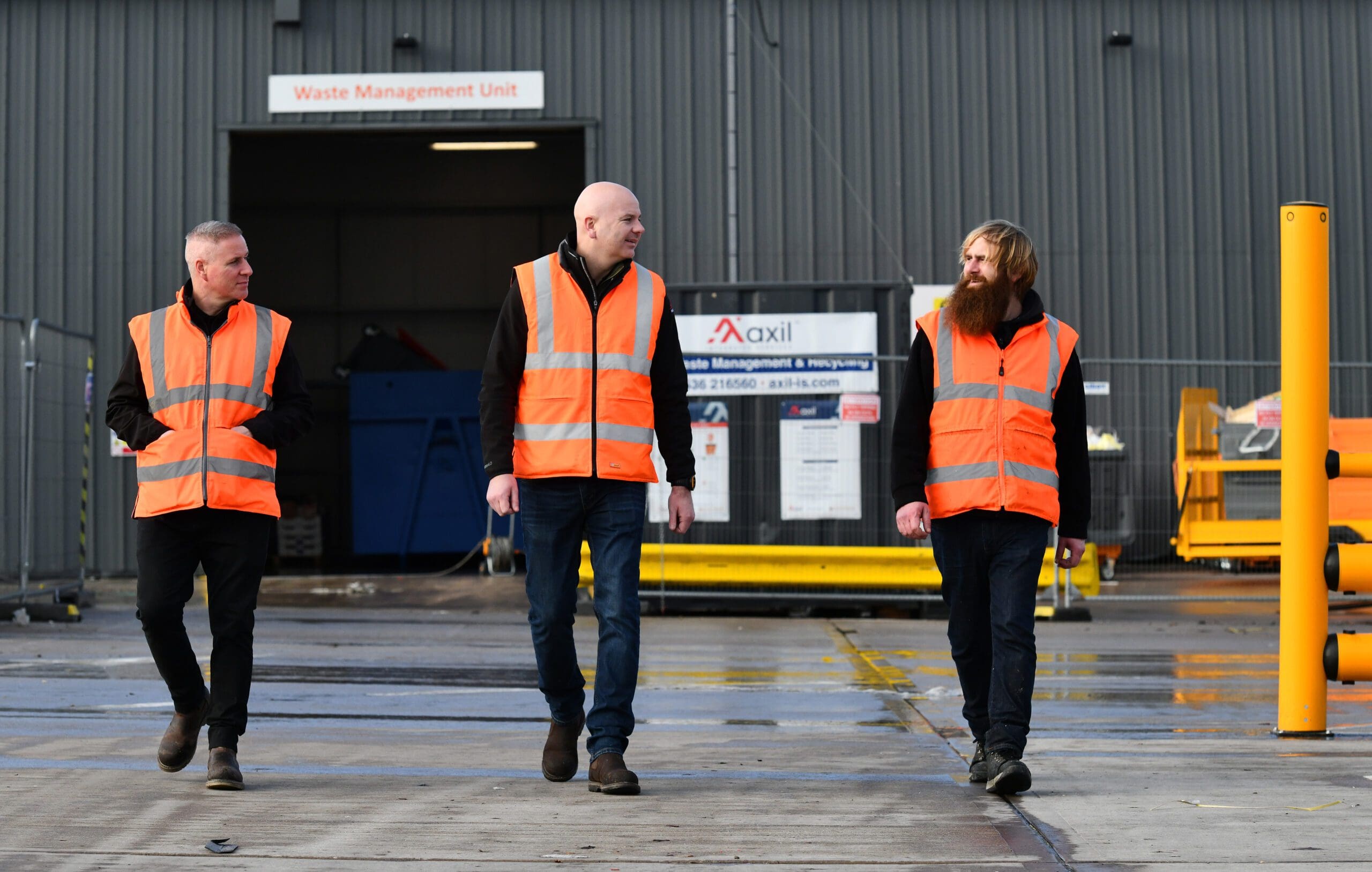 Operatives walking in front of a manufacturing waste management unit