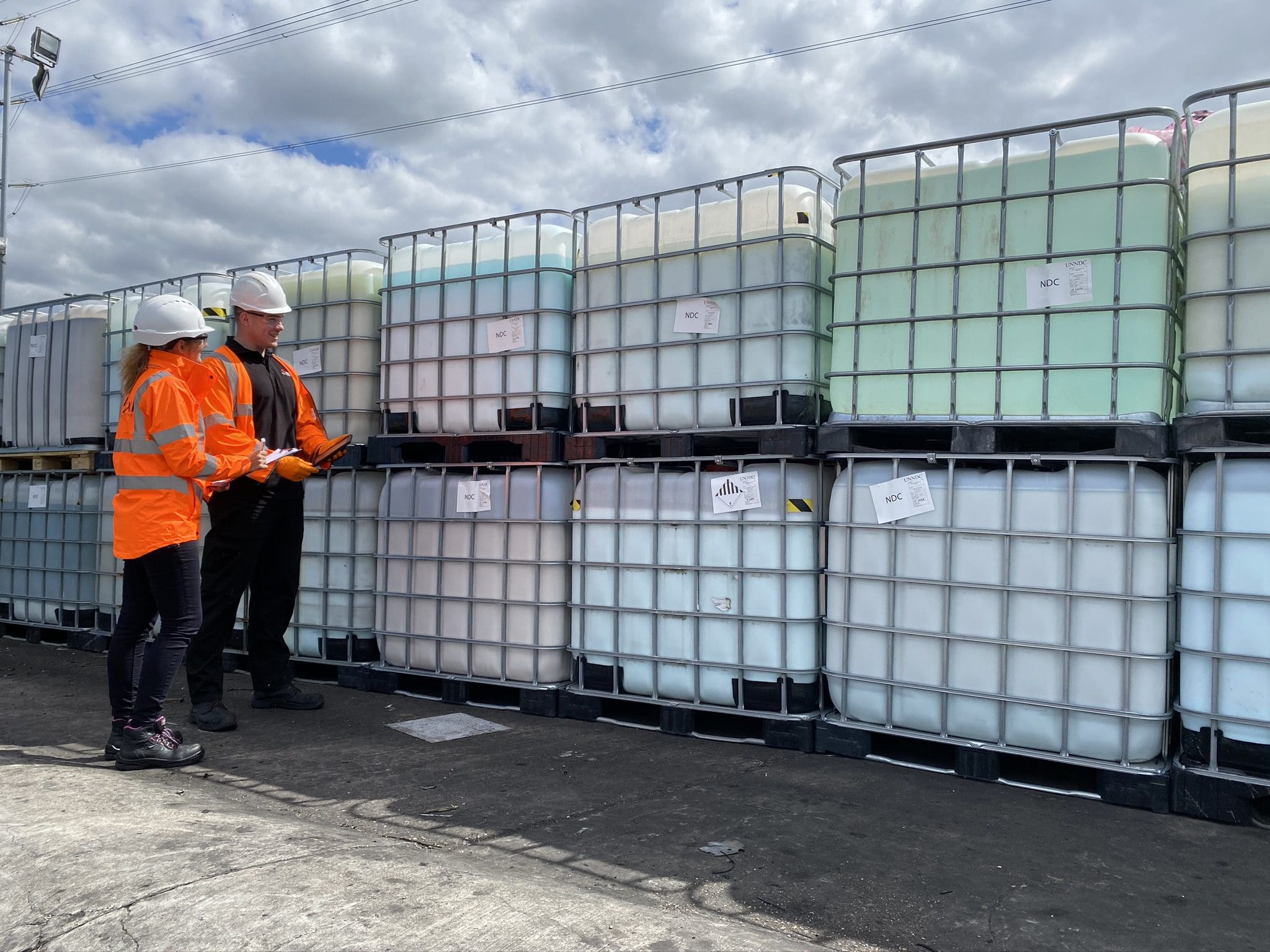 Axil employees inspecting the hazardous waste drums, at the Cannock site
