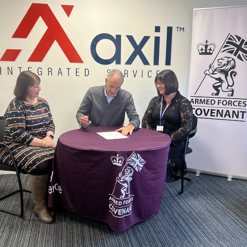 Ed Pigg, and Cathy from Axil signing the armed forces covenant with Kirstie Parker, Deputy Employer Engagement Director from the Ministry of Defence