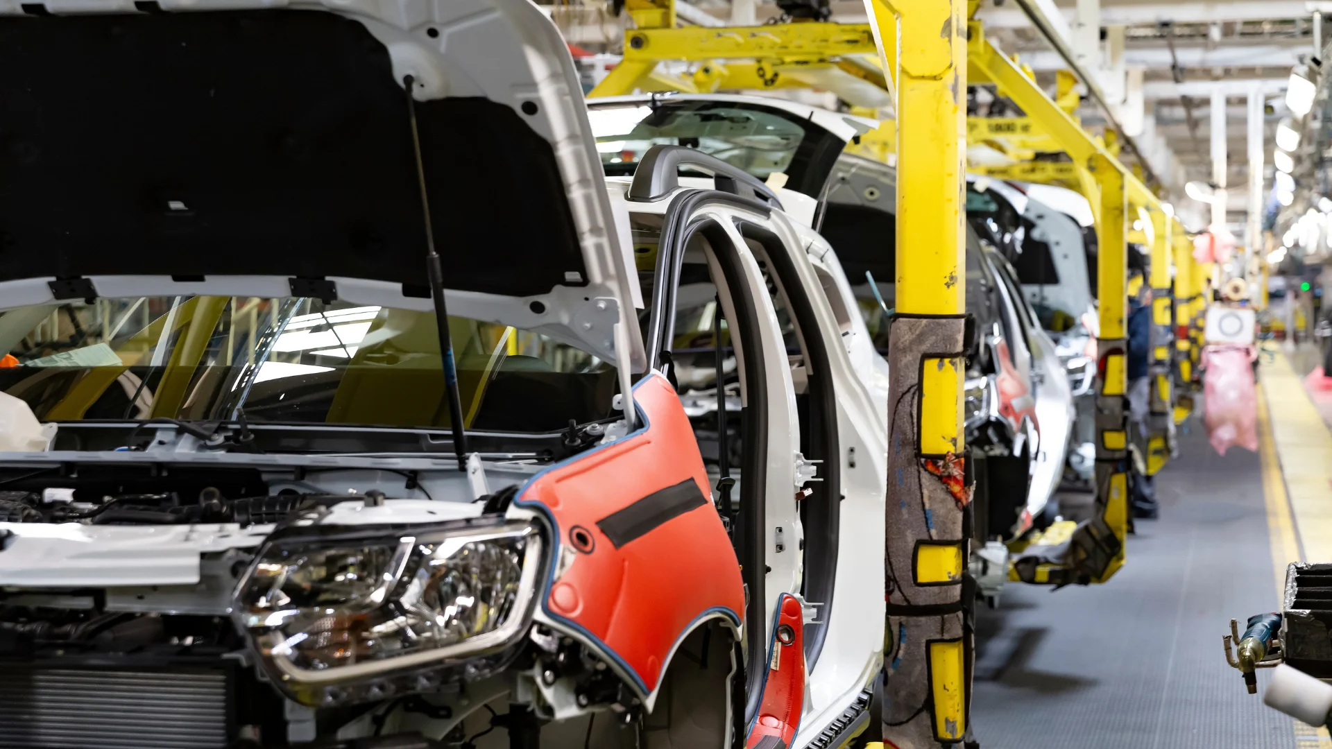 Industrial production of car automobiles. Plant for assembling modern cars on an assembly line. Industry, production, industry concept.
